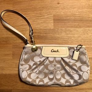 Cream Coach wristlet .
